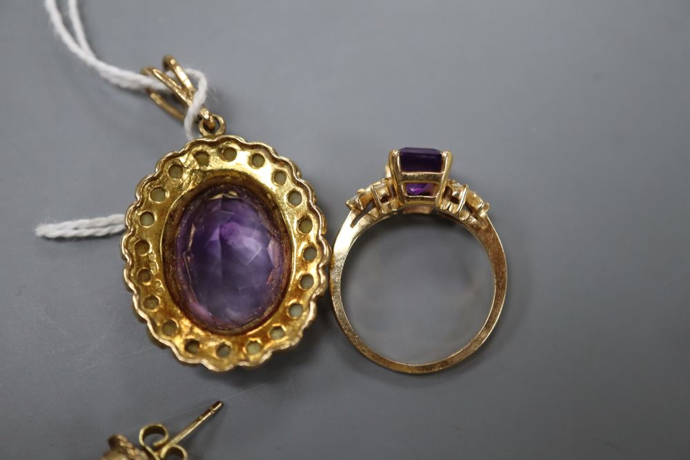 A modern 9ct gold, amethyst and seed pearl set oval pendant, a pair of 9ct and amethyst earstuds and a plated dress ring,